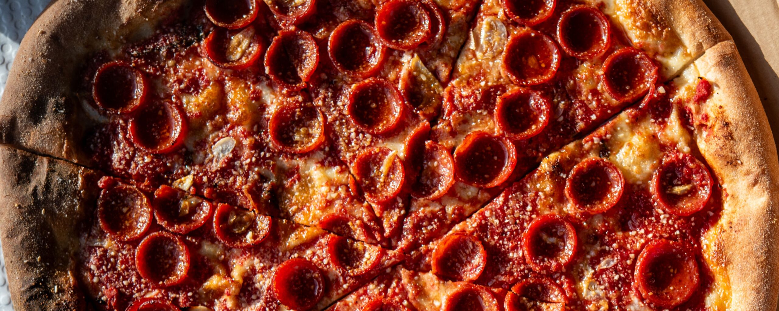 Delicious cupped pepperoni pizza viewed from above